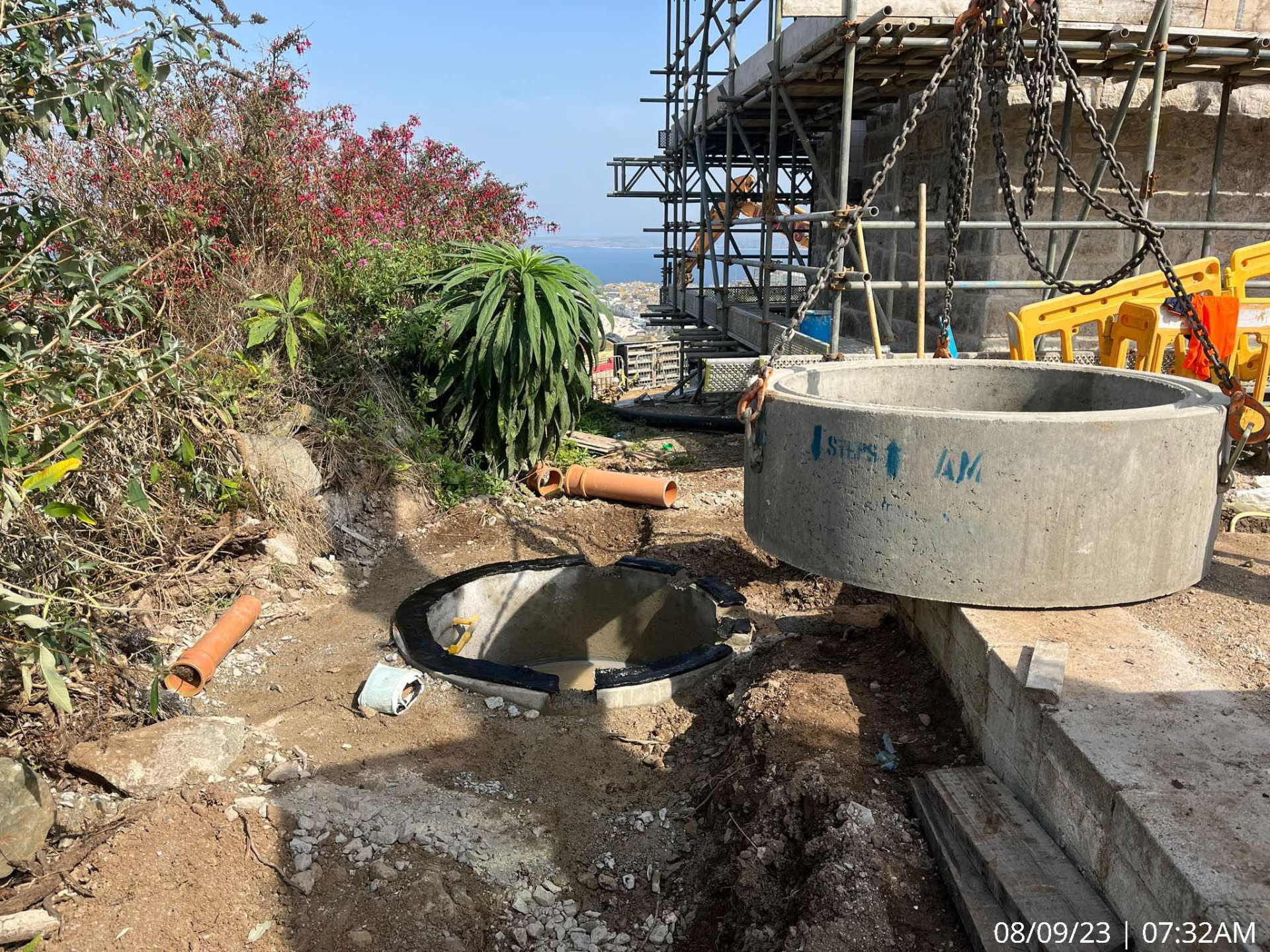 Precast concrete manhole ring being lowered into a new drainage chamber at The Garrack Hotel