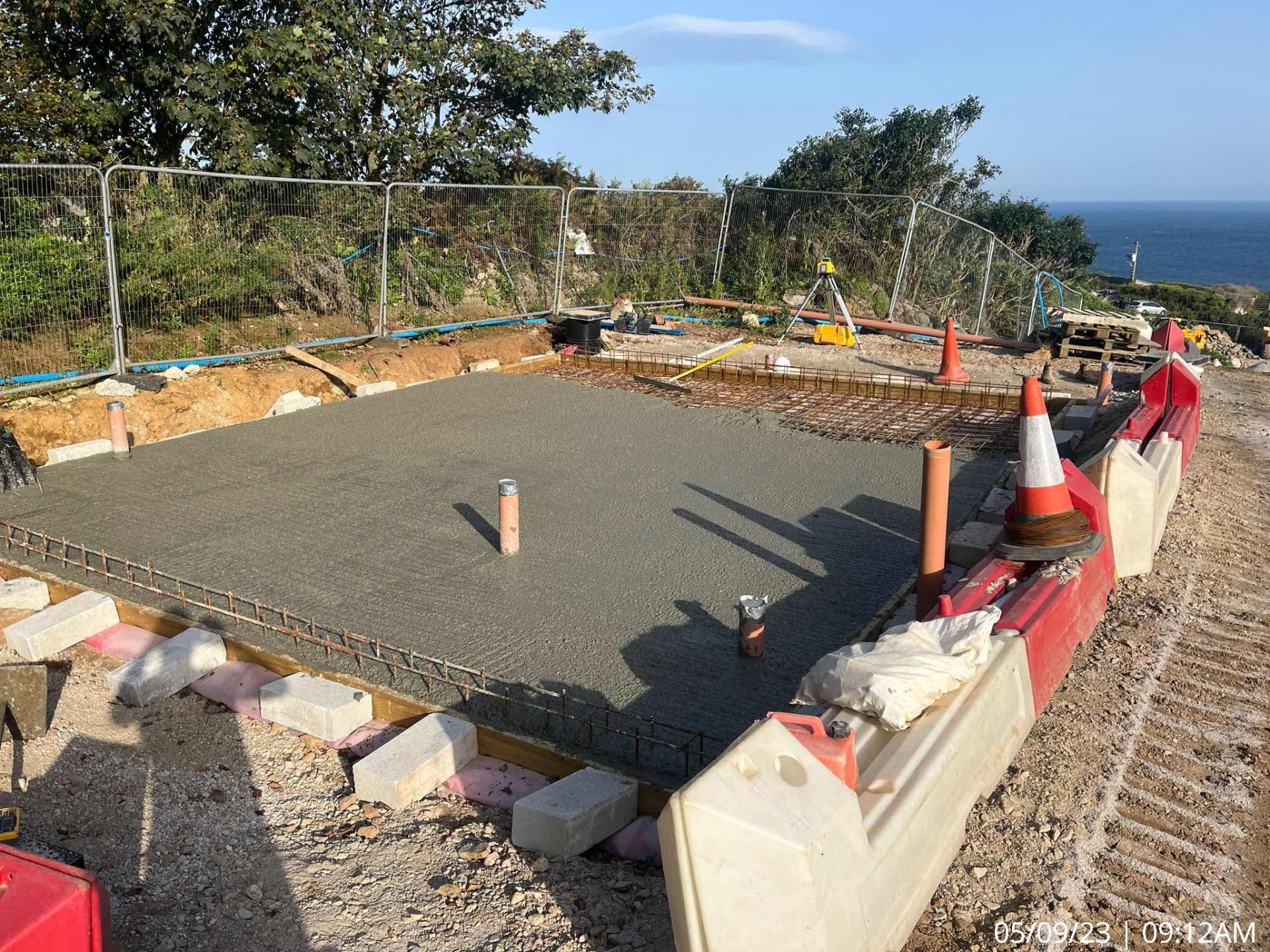 Freshly poured reinforced concrete slab with drainage stubs and sea views at The Garrack Hotel