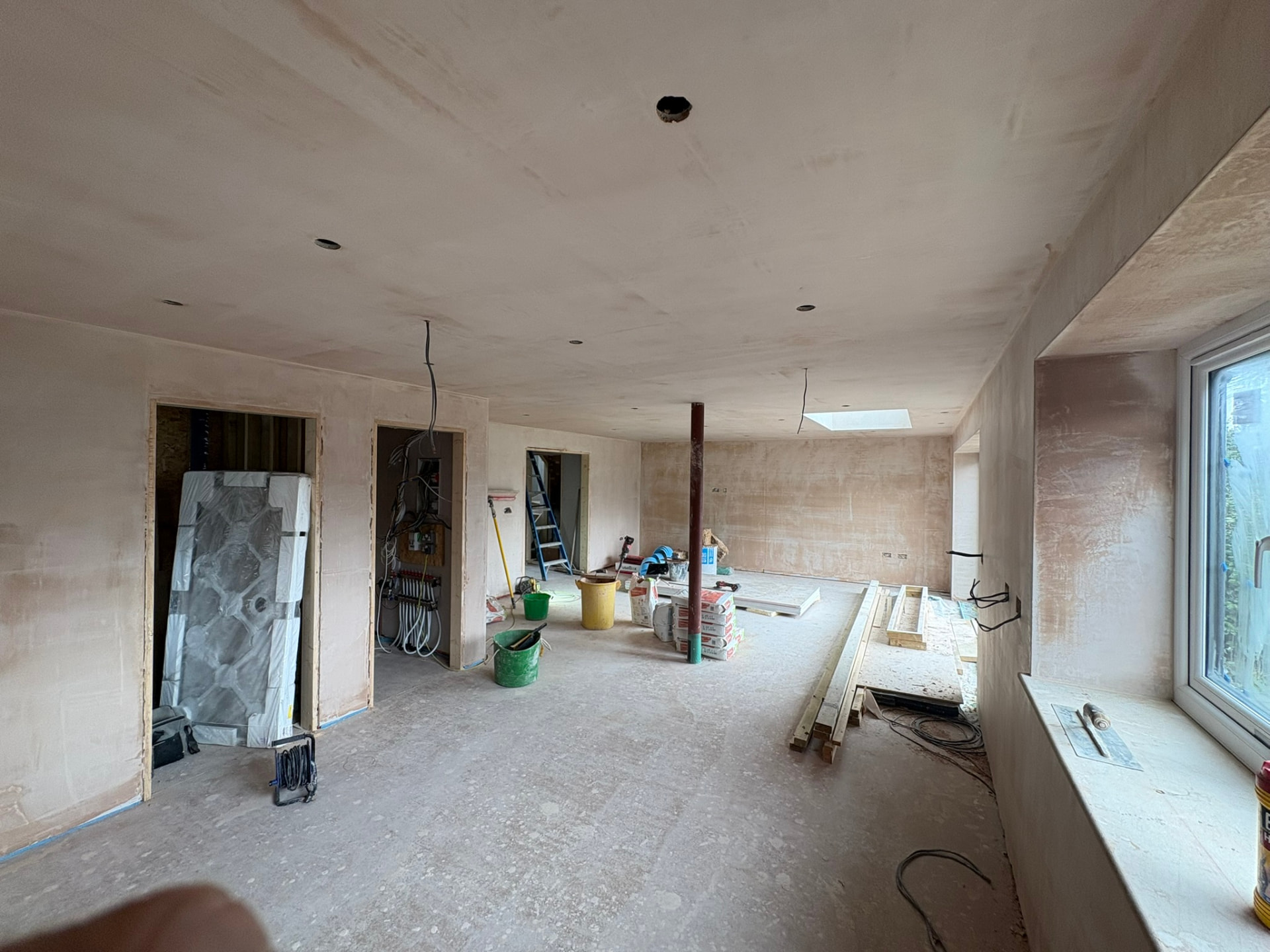 Plastered open-plan interior with new windows and rooflight during the renovation of 3 Polgoon Close