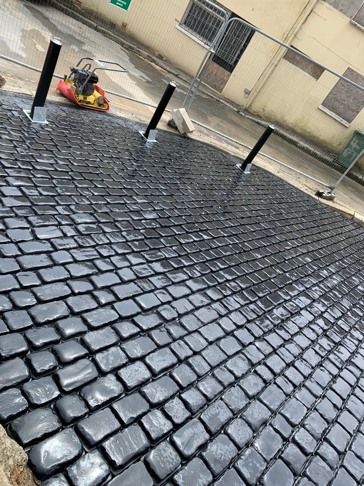 Wet cobbled surface showing the laying pattern and falls across the new driveway in Penzance, Cornwall