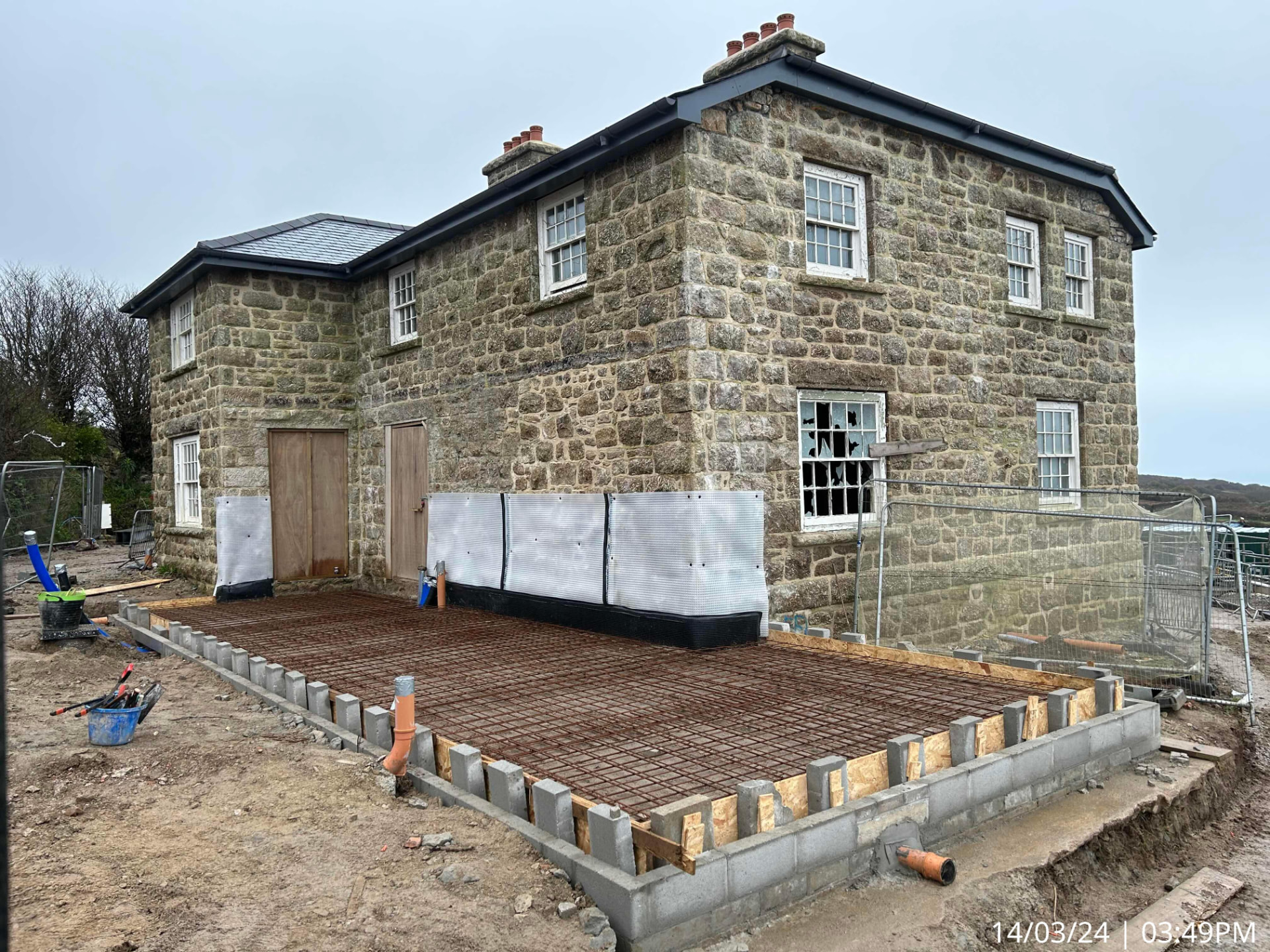 Steel reinforcement mesh laid inside blockwork edging beside the stone Garrack Hotel building in St Ives, Cornwall