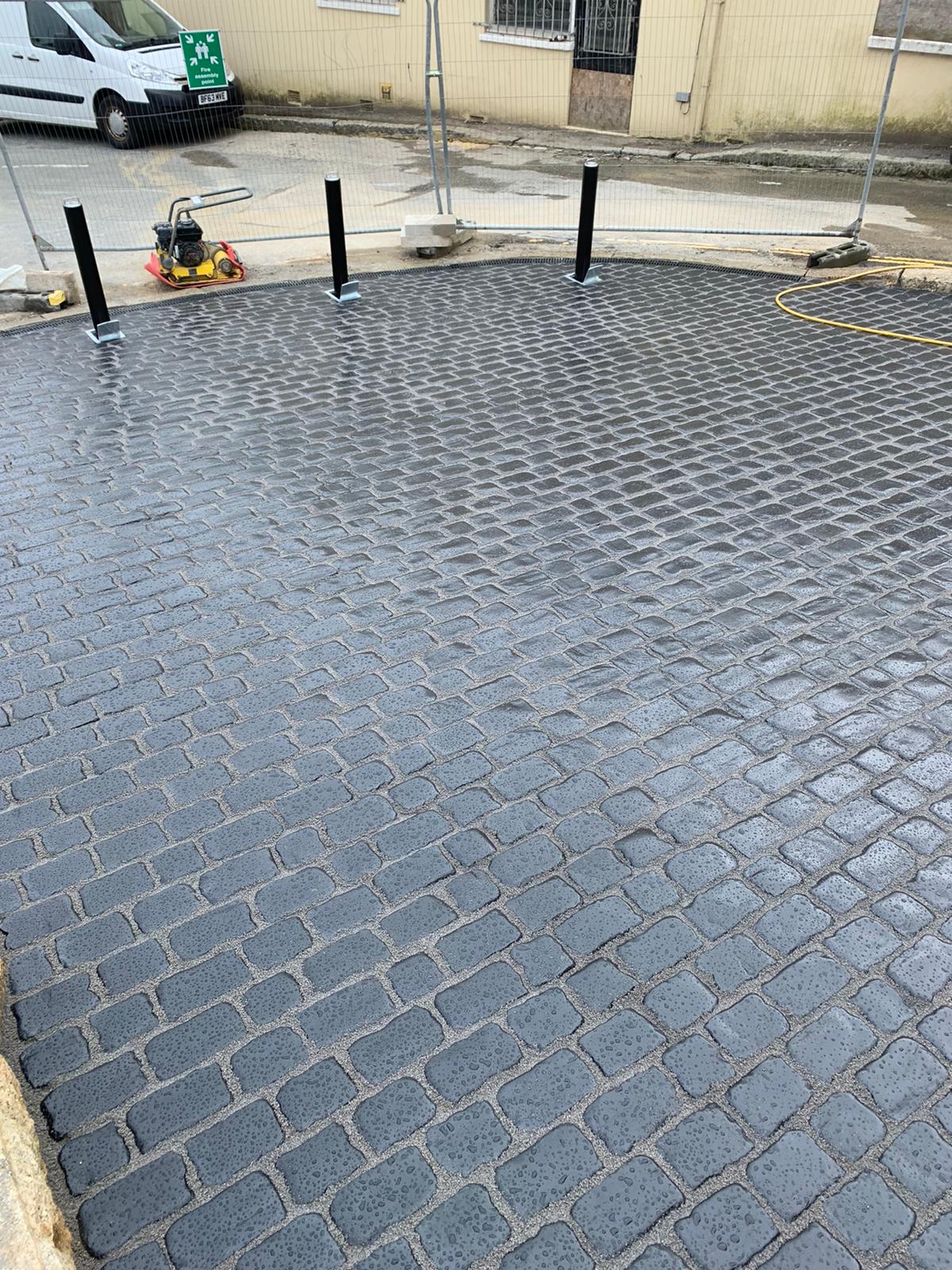 Compaction plate and security bollards on the newly laid cobbled driveway at Lannoweth Road, Penzance