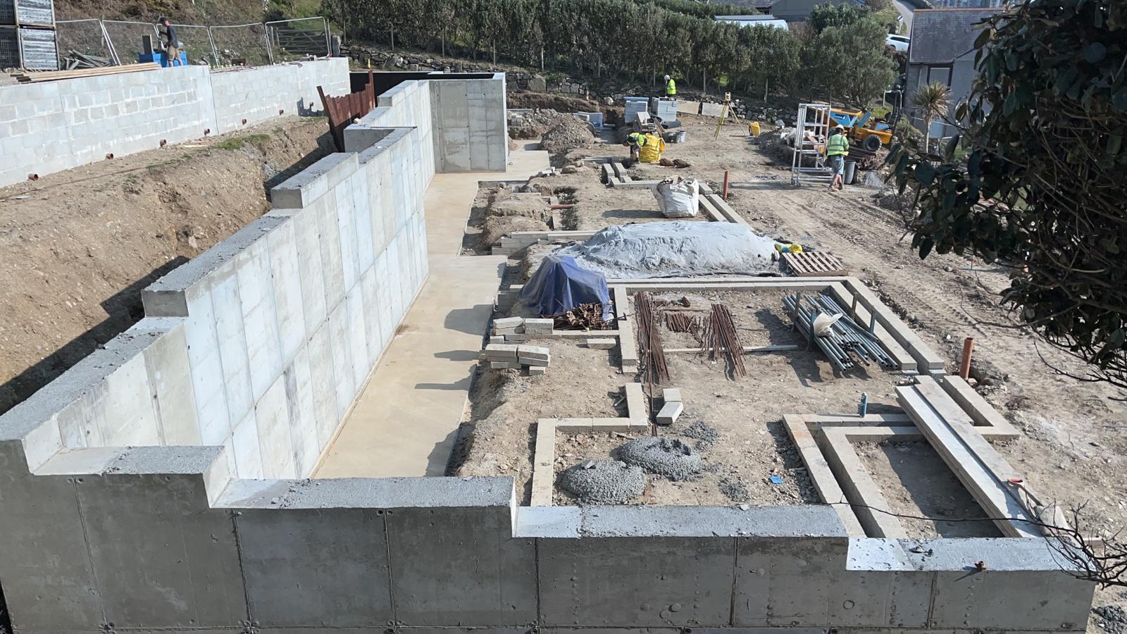 Overhead view of the stepped concrete retaining walls and excavated foundations at the Porthleven new build site