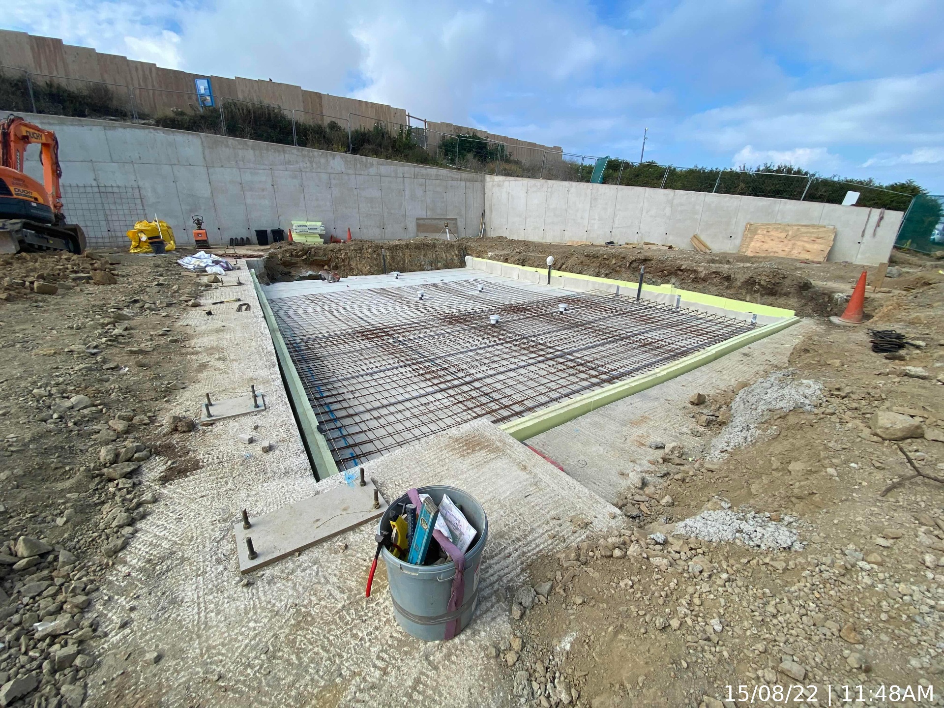 Reinforced concrete slab with steel reinforcement mesh prepared against the retaining wall at AYR Holiday Park