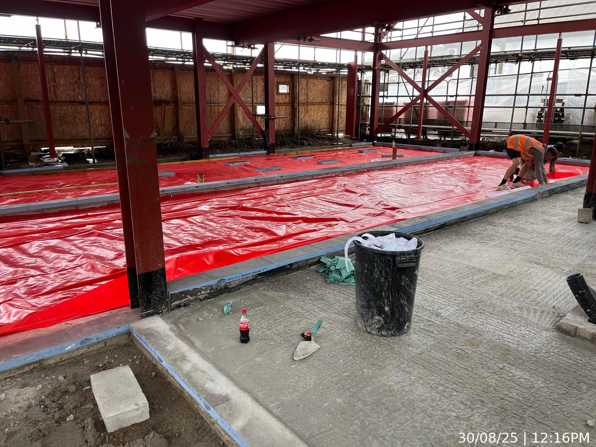 Damp-proof membrane and insulation laid across the steel-framed ground floor slab