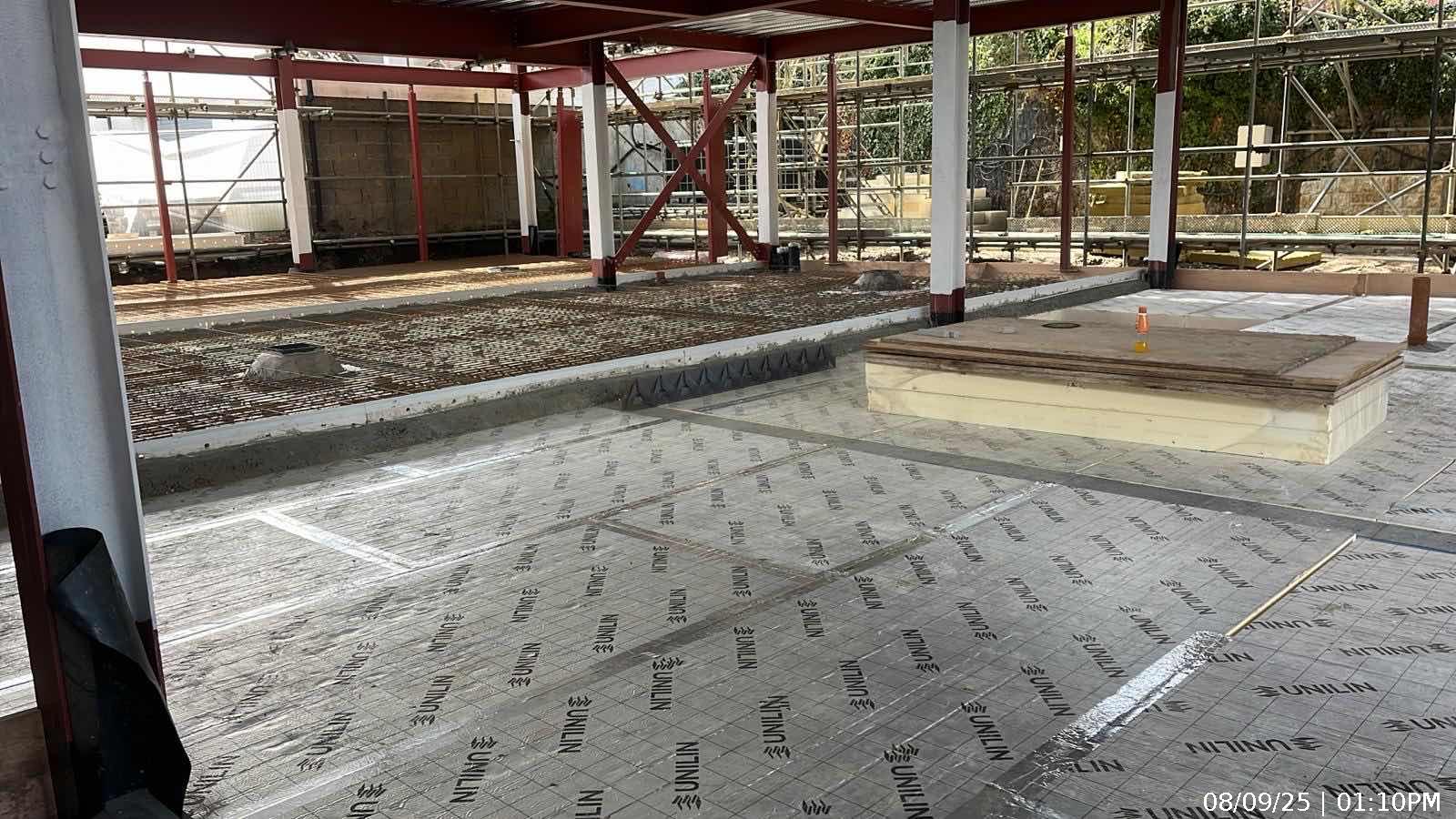 Steel reinforcement bays prepared for the reinforced concrete first-floor slab pour